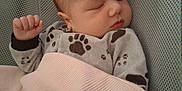 Elvis is registered to the contest to win money with this photo: baby, baby_seat, blanket, child, clothing, cozy, cute, face, hand, indoors, infant, mesh, nap, newborn, paw_prints, peaceful, portrait, resting, sleeping, soft