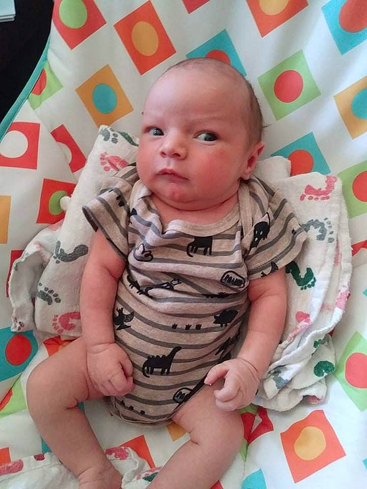 Ben is registered to the contest to win money with this photo: baby, baby_toddler_clothing, cheek, child, comfort, face, facial_expression, fun, happy, head, linens, pattern, people, person, pink, product, sitting, skin, sleeve, textile