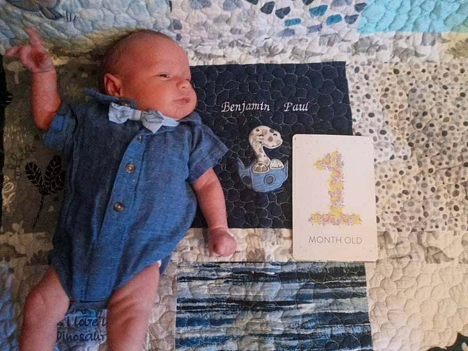 Ben is registered to the contest to win money with this photo: art, baby, baby_toddler_clothing, child, denim, font, happy, linens, pattern, person, photograph, product, room, sitting, sleeve, t_shirt, textile, toddler, vintage_clothing, visual_arts