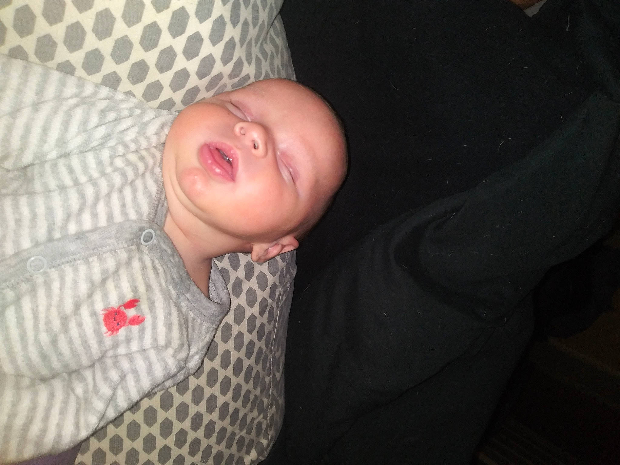 Ben is registered to the contest to win money with this photo: baby, baby_toddler_clothing, cheek, comfort, eyebrow, flash_photography, flesh, fun, iris, linens, lip, mouth, nail, nose, pattern, person, sitting, sleep, sleeve, smile