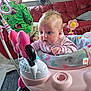 Ava-Melody joined the competition — help win amazing prizes! baby, toddler, baby_walker, toy, pink, green, couch, indoor, child, clothing, play, curious, person, living_room, floor, head, face, furniture, colorful, home