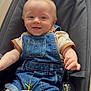 baby, child, infant, denim_overalls, beige_shirt, blue_eyes, smiling, baby_seat, toy, colorful_toy, polka_dots, wooden_toy, comfort, indoor, cute, happy, playful, small_hands, sitting, portrait
