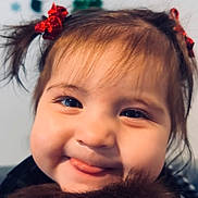 Citlali is registered to the contest to win money with this photo: child, toddler, face, smile, tongue, hair_ties, pigtails, christmas, decoration, stocking, tree, holiday, fuzzy, close_up, happy, cute, indoors, portrait, young, playful
