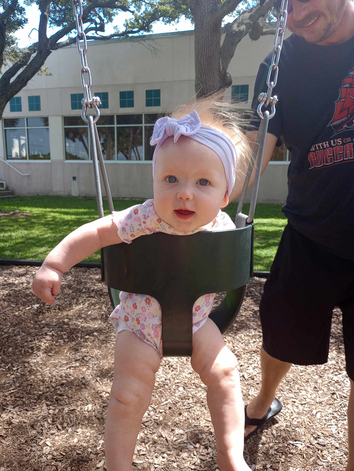 Abigail joined the competition — help win amazing prizes! baby, child, swing, playground, outdoor, headband, smile, adult, grass, tree, sunlight, building, person, happy, legs, clothing, summer, fun, park, woodchips