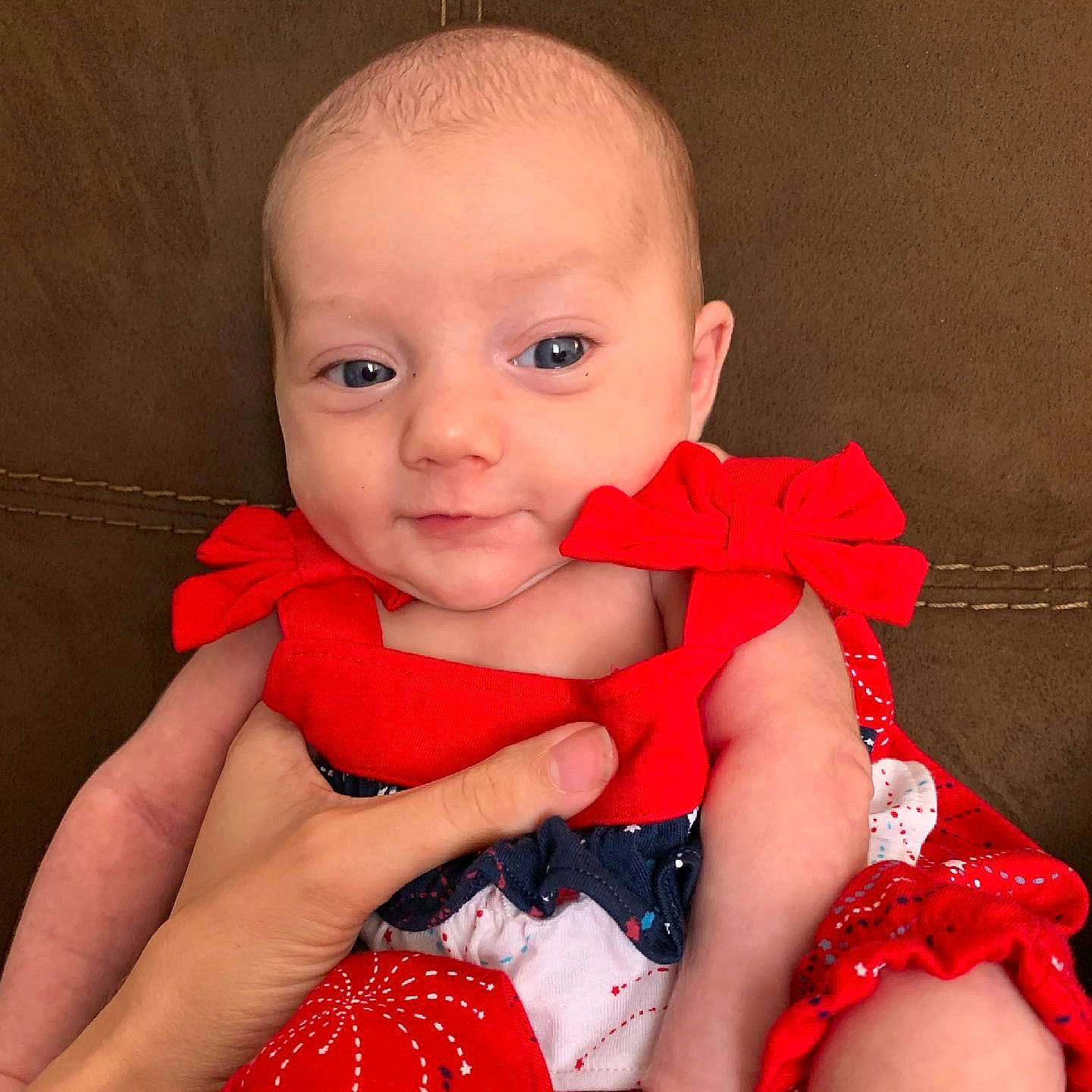 Annaleigh is registered to the contest to win money with this photo: arm, baby, baby_toddler_clothing, cheek, dress, eye, finger, flash_photography, hand, happy, iris, lip, neck, one_piece_garment, person, pink, red, skin, sleeve, thumb