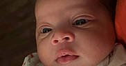 Dalani is registered to the contest to win money with this photo: baby, blanket, child, clothing, curious, cute, expression, eyes, face, human, indoors, infant, newborn, person, portrait, skin, soft_lighting, warmth, wrapped, young