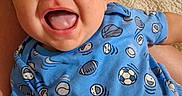 William joined the competition — help win amazing prizes! baby, child, infant, smiling, happy, blue_clothing, onesie, sports_pattern, indoor, carpet, blanket, portrait, cute, young_child, person, head, face, cheerful, closeup, sitting