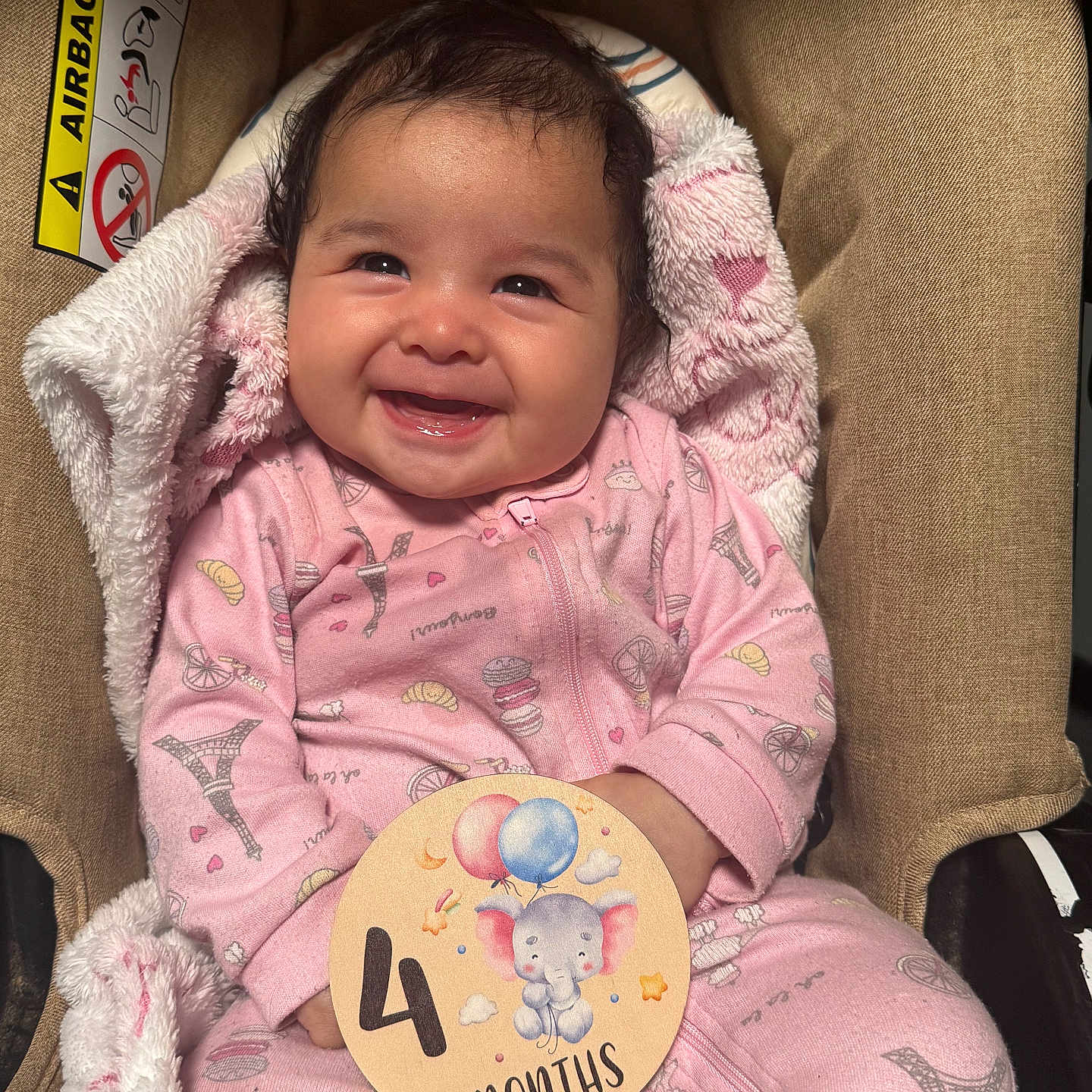 Xialani is registered to the contest to win money with this photo: baby, infant, smiling, pink_onesie, car_seat, milestone_card, elephant_illustration, balloons, cute, happy, child, face, portrait, blanket, cozy, patterned_clothing, indoor, young_child, celebration, four_months