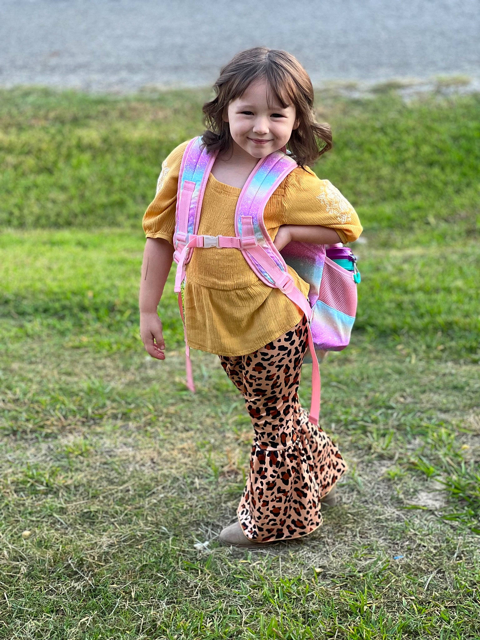 Addalynn is registered to the contest to win money with this photo: bag, brown_hair, child, fun, grass, grass_family, grassland, happy, human_leg, joy, leisure, luggage_and_bags, pattern, people_in_nature, person, prairie, recreation, scarf, sleeve, smile
