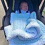 baby, blanket, blue, carriage, child, cozy, cute, daylight, face, infant, outdoor, person, pram, sleeping, stroller, transport, walkway, young, young_child, wrapped