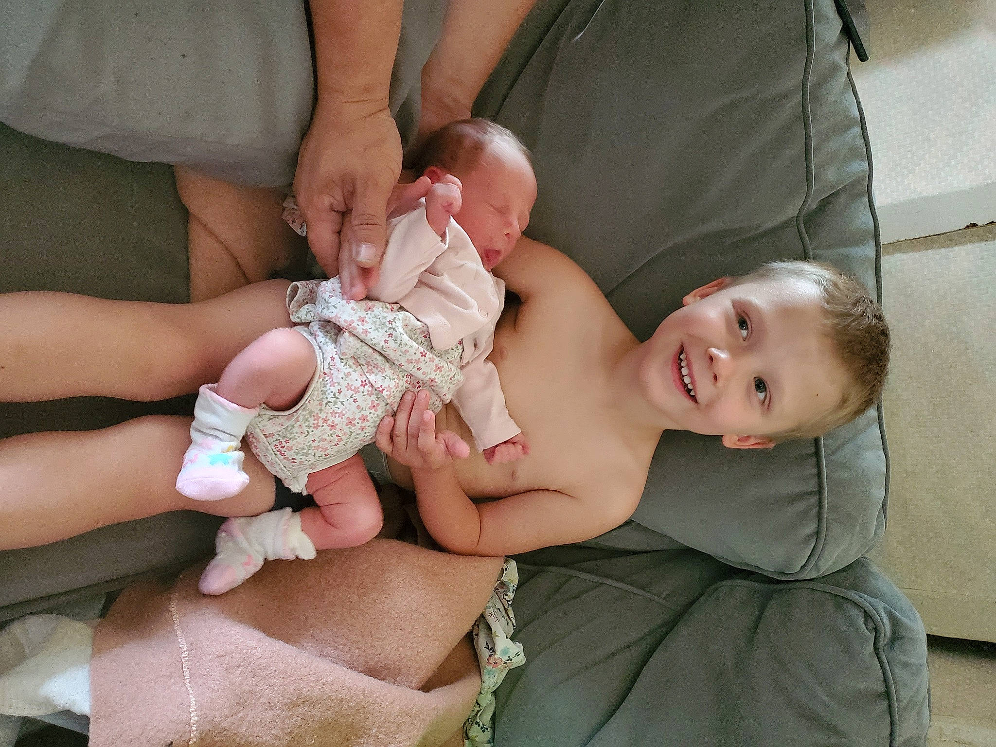 Sean is registered to the contest to win money with this photo: abdomen, baby, baby_toddler_clothing, child, comfort, finger, flash_photography, foot, gesture, grass, hand, happy, joy, nail, pattern, people, person, sitting, skin, smile