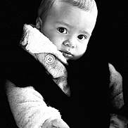 Tiago participe au concours pour gagner de l'argent avec cette photo : baby, child, portrait, black_and_white, coat, button, hand, face, eyes, expression, cute, warm_clothing, infant, soft_texture, closeup, small_fingers, looking, innocence, young, person