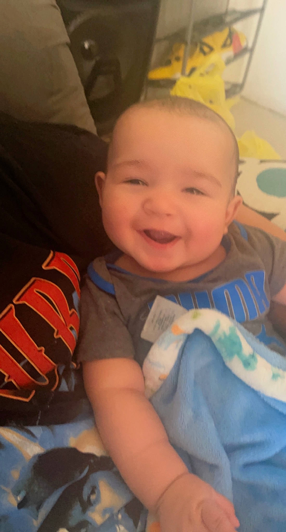 Raymond is registered to the contest to win money with this photo: arm, baby, baby_toddler_clothing, cheek, chin, comfort, cool, eye, eyebrow, facial_expression, finger, forehead, happy, iris, mouth, nose, person, skin, smile, standing