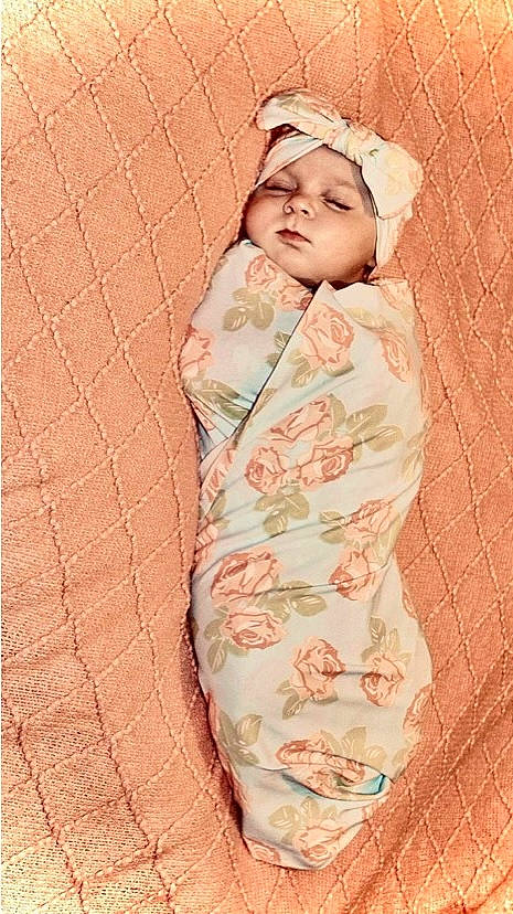 Kamora is registered to the contest to win money with this photo: baby, baby_products, baby_sleeping, baby_toddler_clothing, camouflage, cap, child, comfort, face, fur, headwear, linens, military_camouflage, pattern, peach, person, pink, skin, sleeve, toddler