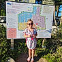 Mia a rejoint le concours — aidez-le/la à gagner de superbes lots ! child, girl, sunglasses, sign, map, outdoor, sunlight, trees, rocks, plants, dress, footwear, nature, smile, person, summer, travel, vacation, holiday, tourist
