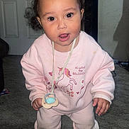 Halo joined the competition — help win amazing prizes! toddler, child, pink_clothing, pigtails, pacifier, unicorn_print, indoor, carpet, sneaker, sock, cute, curious, person, smiling, hair_accessory, baby, young_child, standing, floor, playful