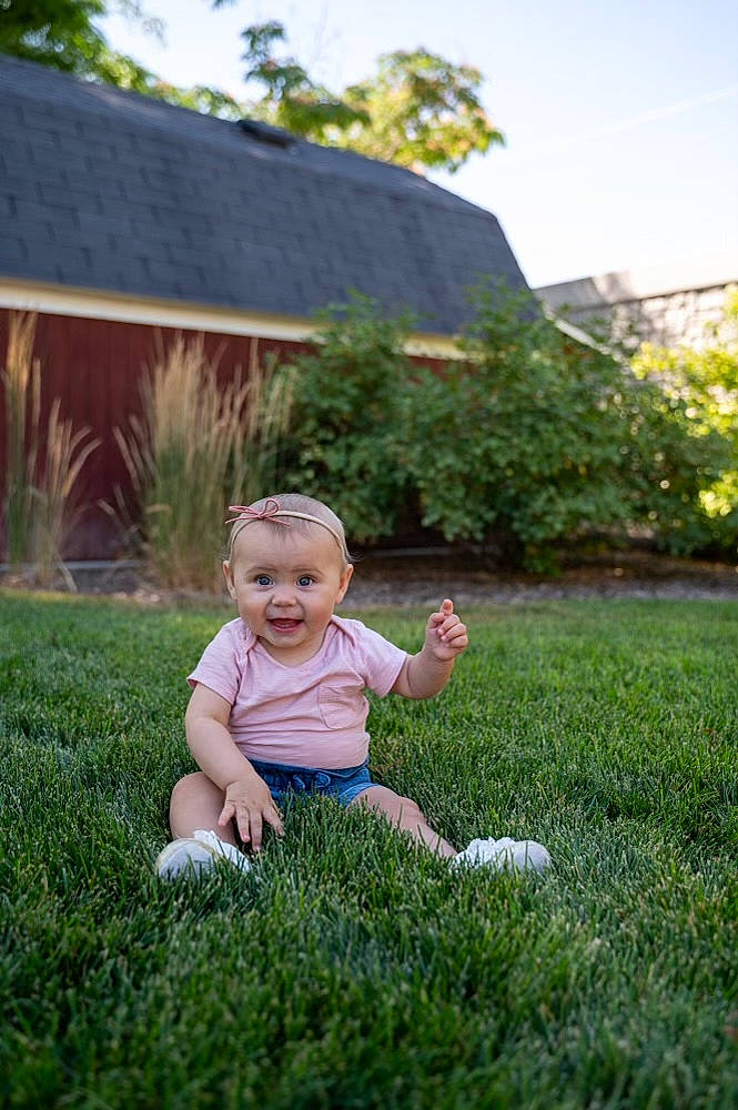 Coraline is registered to the contest to win money with this photo: baby, baby_toddler_clothing, botany, grass, grass_family, grassland, happy, house, landscape, leg, leisure, meadow, people_in_nature, person, plant, sky, smile, summer, toddler, tree