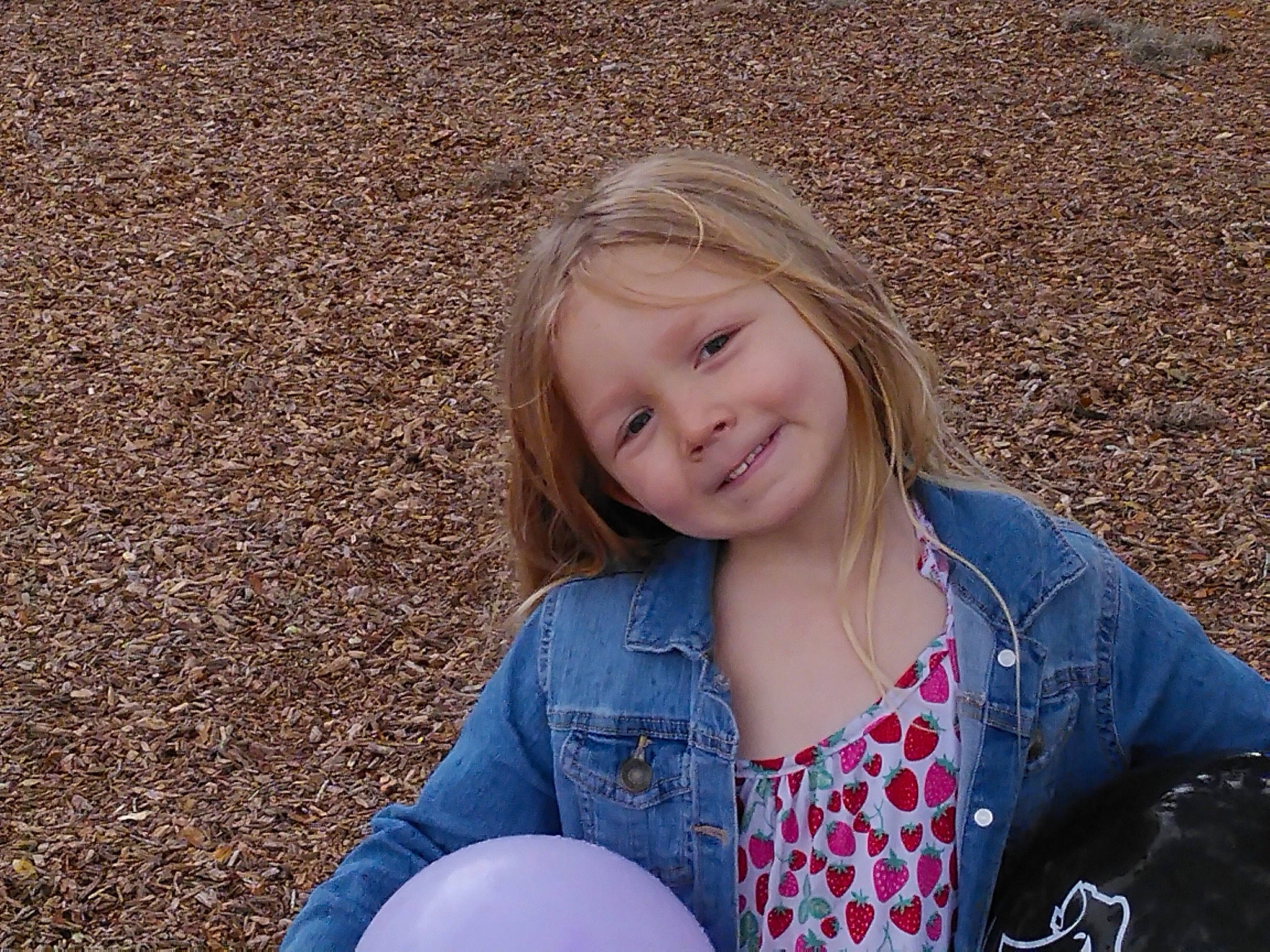 Clarissa is registered to the contest to win money with this photo: balloon, beauty, blond, brown_hair, child, denim, electric_blue, fun, grass, happy, joy, leisure, party_supply, pattern, people_in_nature, person, play, recreation, sitting, smile