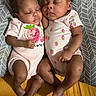 baby, sleeping, infant, onesie, patterned_clothing, cushion, sleep, peaceful, cute, child, toddler, indoor, rest, matching_outfits, pink_clothing, newborn, portrait, closeup, family, adorable