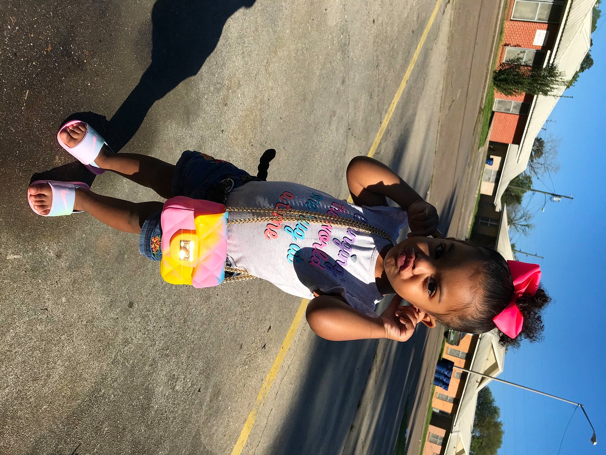 Christin joined the competition — help win amazing prizes! asphalt, child, concrete, fun, happy, human_leg, leisure, outdoor_shoe, pedestrian, person, recreation, shadow, sky, tire, toddler, travel, walking_shoe, wheel