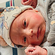 Jayce joined the competition — help win amazing prizes! newborn, baby, infant, hat, clothing, face, hand, skin, eyes, portrait, closeup, sleepwear, cute, cozy, lying_down, person, newborn_clothing, baby_hat, soft_light, indoors