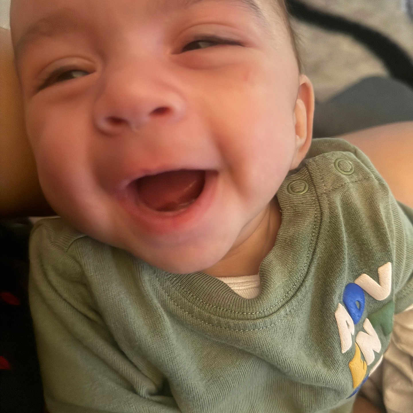 Jayden joined the competition — help win amazing prizes! baby, child, closeup, clothing, cute, expression, face, green_shirt, happy, human, indoors, infant, joy, mouth_open, person, portrait, sitting, skin, smiling, young