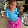 Sapphirerose is registered to the contest to win money with this photo: child, girl, toddler, portrait, smiling, indoor, living_room, blue_shirt, pink_skirt, tutu, butterfly, hair_bows, earrings, standing, couch, blanket, bookshelf, television, floor, home