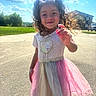 child, girl, curly_hair, smiling, portrait, outdoor, sunny, sky, clouds, dress, tulle_skirt, rainbow_colors, pink, hand_gesture, suburban, driveway, house, car, grass, summer