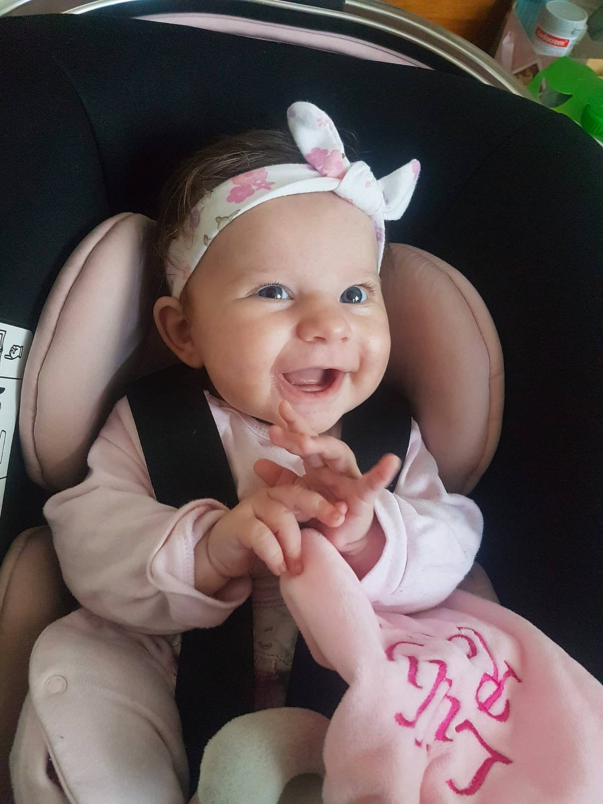 Lilly Rose is registered to the contest to win money with this photo: baby, birth, car_seat, cheek, child, daughter, ear, finger, hair_accessory, headband, headgear, person, pink, skin, smile, thumb, toddler