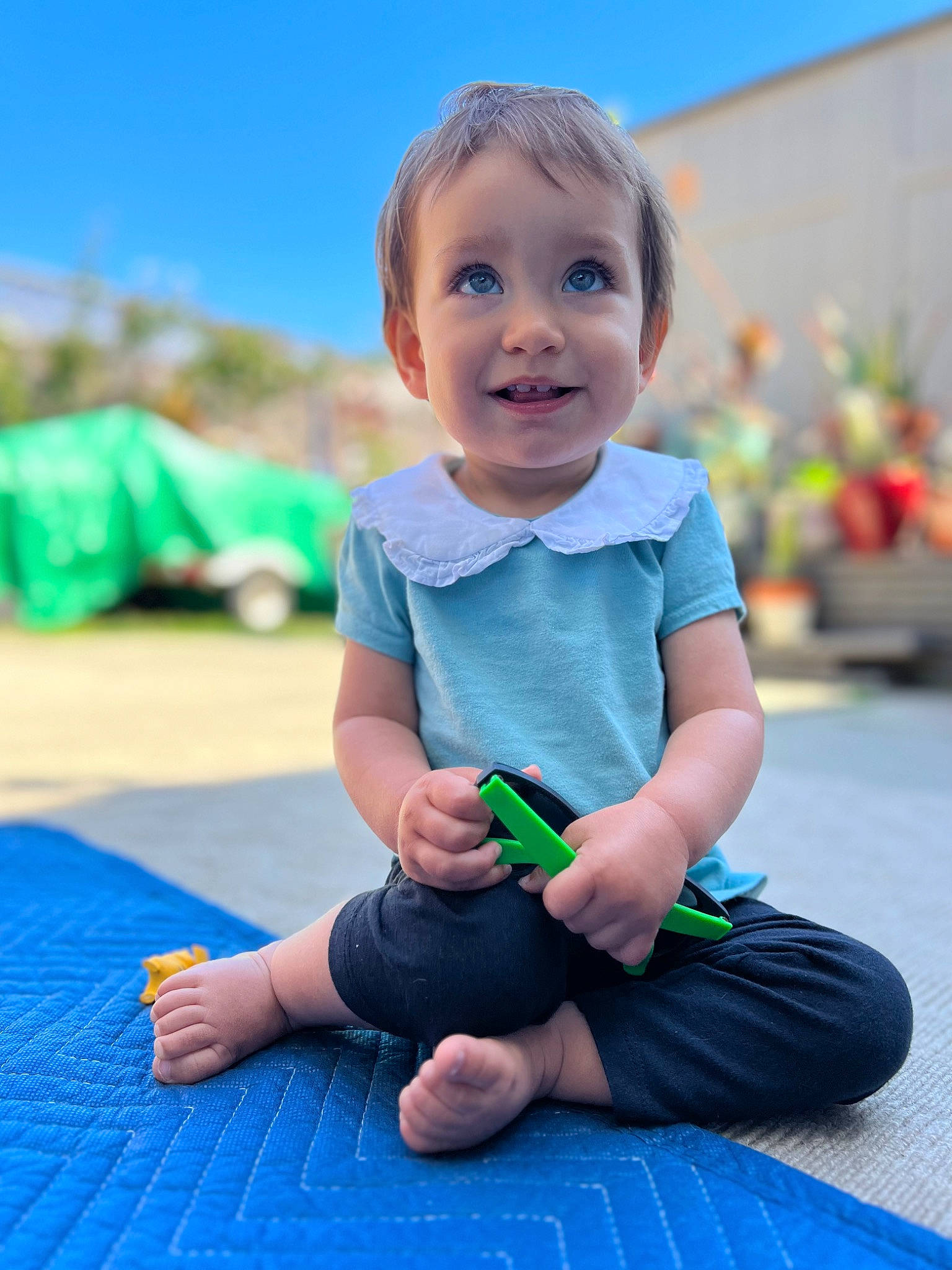 Ariana joined the competition — help win amazing prizes! baby, baby_toddler_clothing, blue, electric_blue, facial_expression, flooring, fun, grass, happy, joy, leisure, people_in_nature, person, plant, recreation, sitting, skin, sky, sleeve, smile
