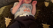 Derrick is registered to the contest to win money with this photo: baby, infant, blanket, clothing, socks, face, person, indoor, baby_wipes, couch, pattern, toddler, cute, resting, newborn, soft_lighting, casual, comfort, small_hands, young_child