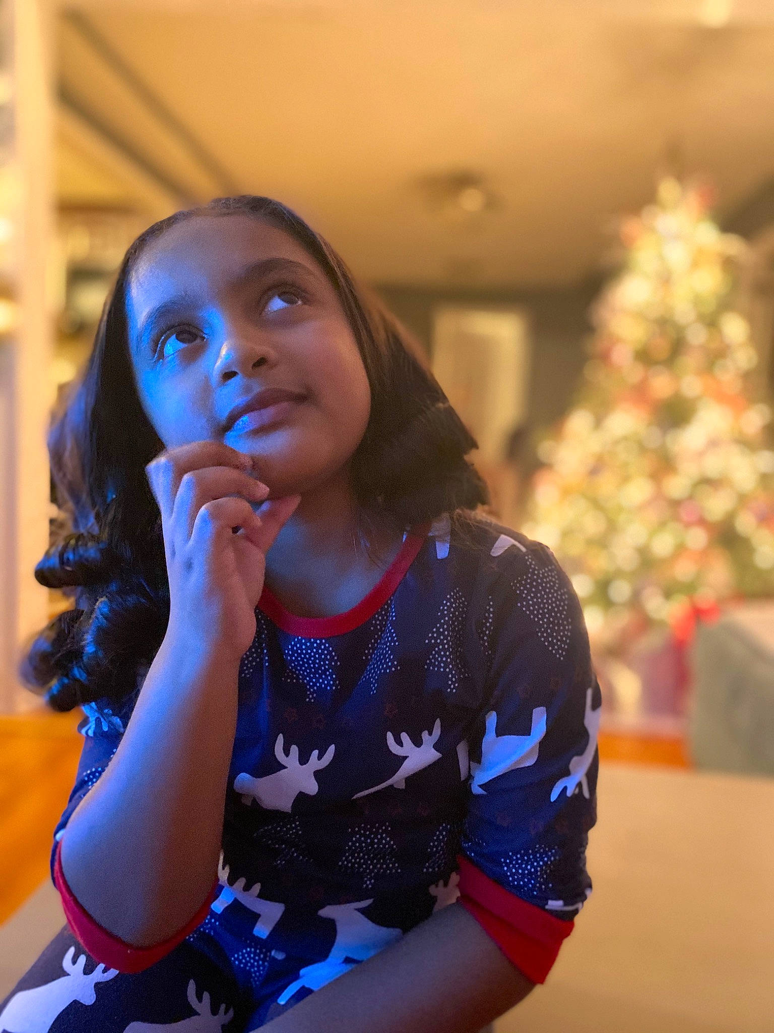 Hazel is registered to the contest to win money with this photo: beauty, child, christmas_tree, conifer, electric_blue, event, fun, happy, holiday, jewellery, joy, leisure, long_hair, necklace, ornament, pattern, person, room, sitting, t_shirt