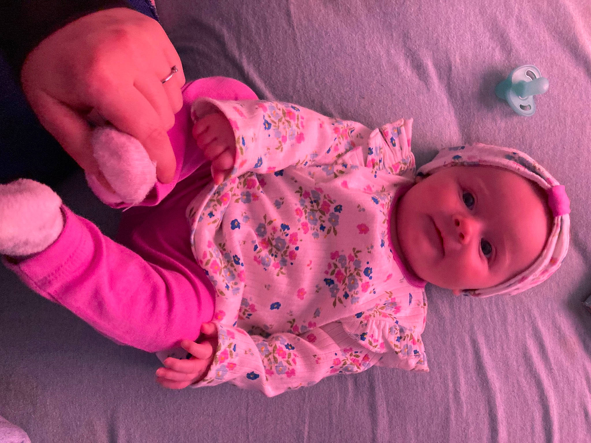 Alice is registered to the contest to win money with this photo: baby, baby_toddler_clothing, cheek, comfort, face, head, headgear, human_body, lip, mammal, mouth, nose, person, pink, purple, skin, sleeve, textile, toddler, vertebrate