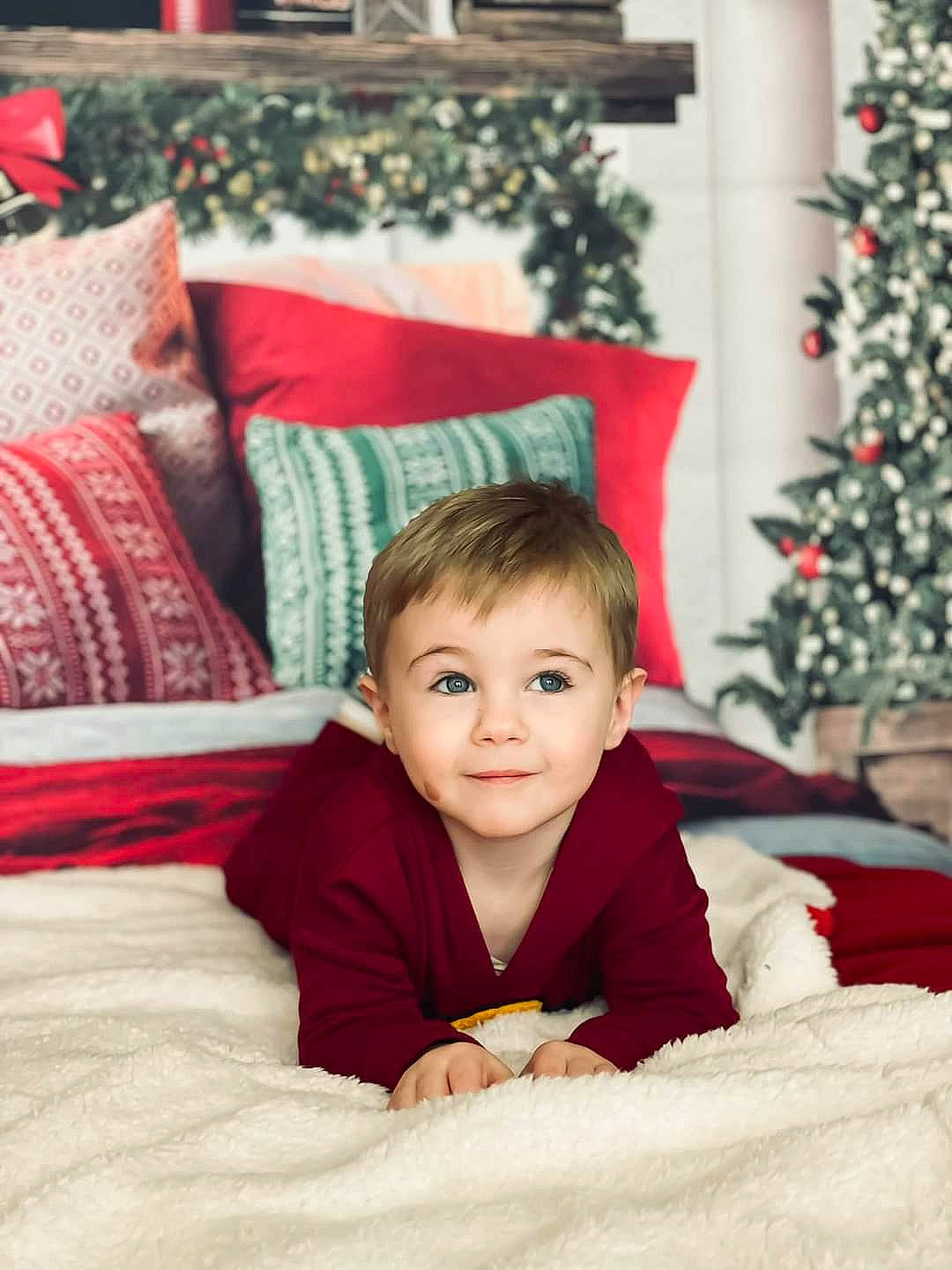 Brendan is registered to the contest to win money with this photo: baby, child, christmas_decoration, christmas_ornament, christmas_tree, comfort, event, eye, face, fun, hair, happy, head, holiday, joy, linens, person, plant, sitting, smile