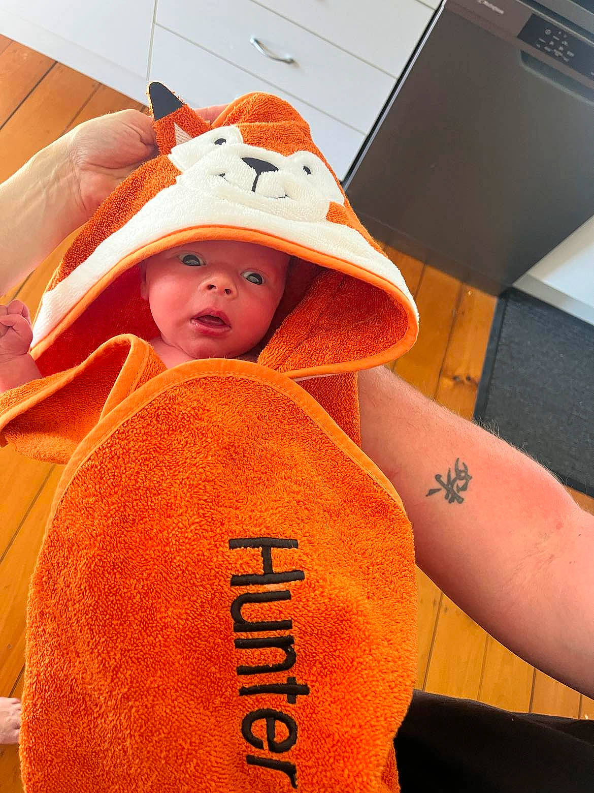 Hunter is registered to the contest to win money with this photo: baby, cap, child, comfort, cool, elbow, fashion_accessory, font, gesture, hat, headgear, headwear, lifejacket, orange, outerwear, peach, person, personal_protective_equipment, sleeve, t_shirt