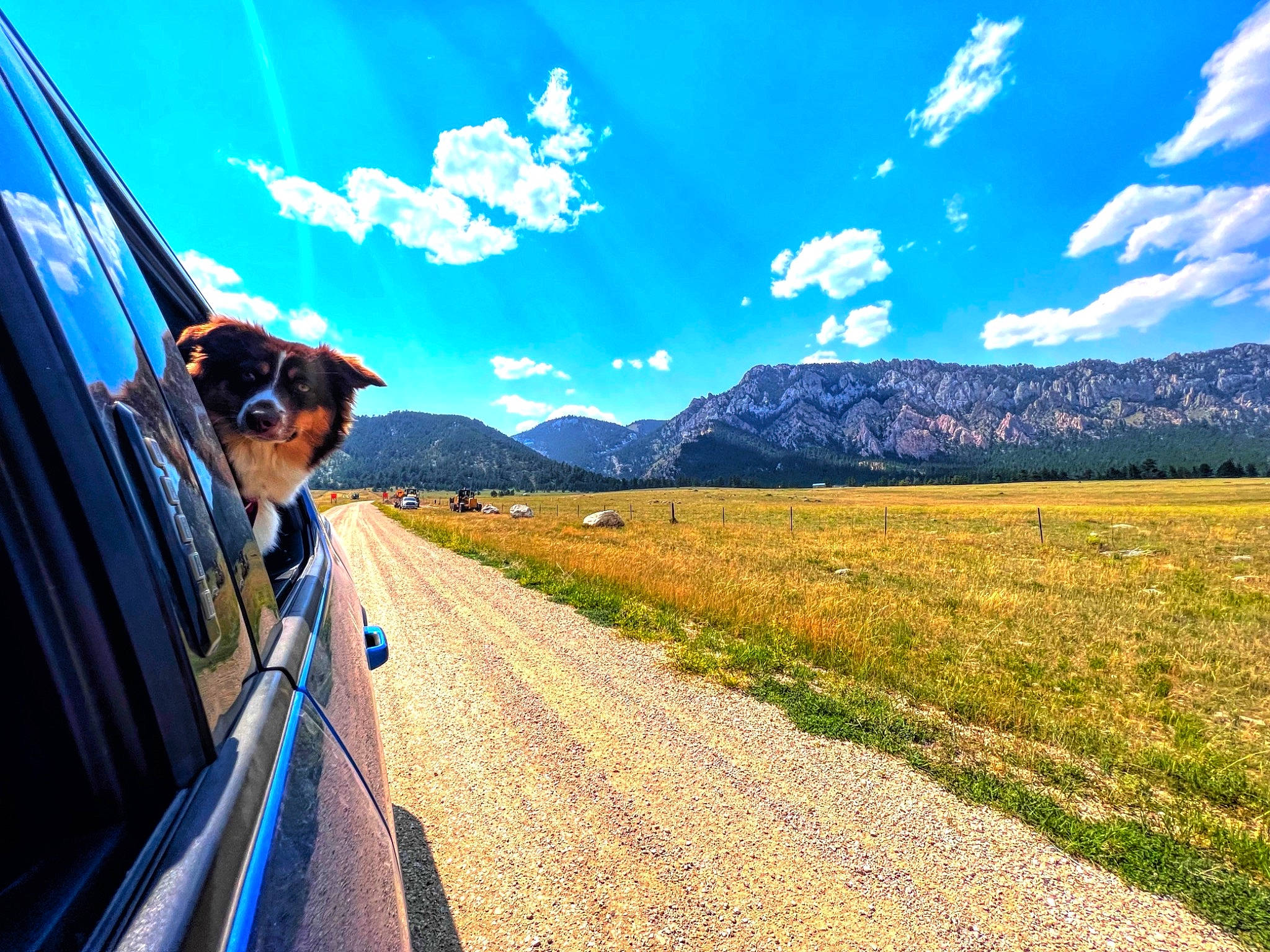 Baylor joined the competition — help win amazing prizes! asphalt, automotive_design, automotive_lighting, automotive_mirror, automotive_tire, blue, car, cloud, daytime, grass, motor_vehicle, mountain, natural_landscape, people_in_nature, plant, road_surface, sky, sunglasses, sunlight, vehicle