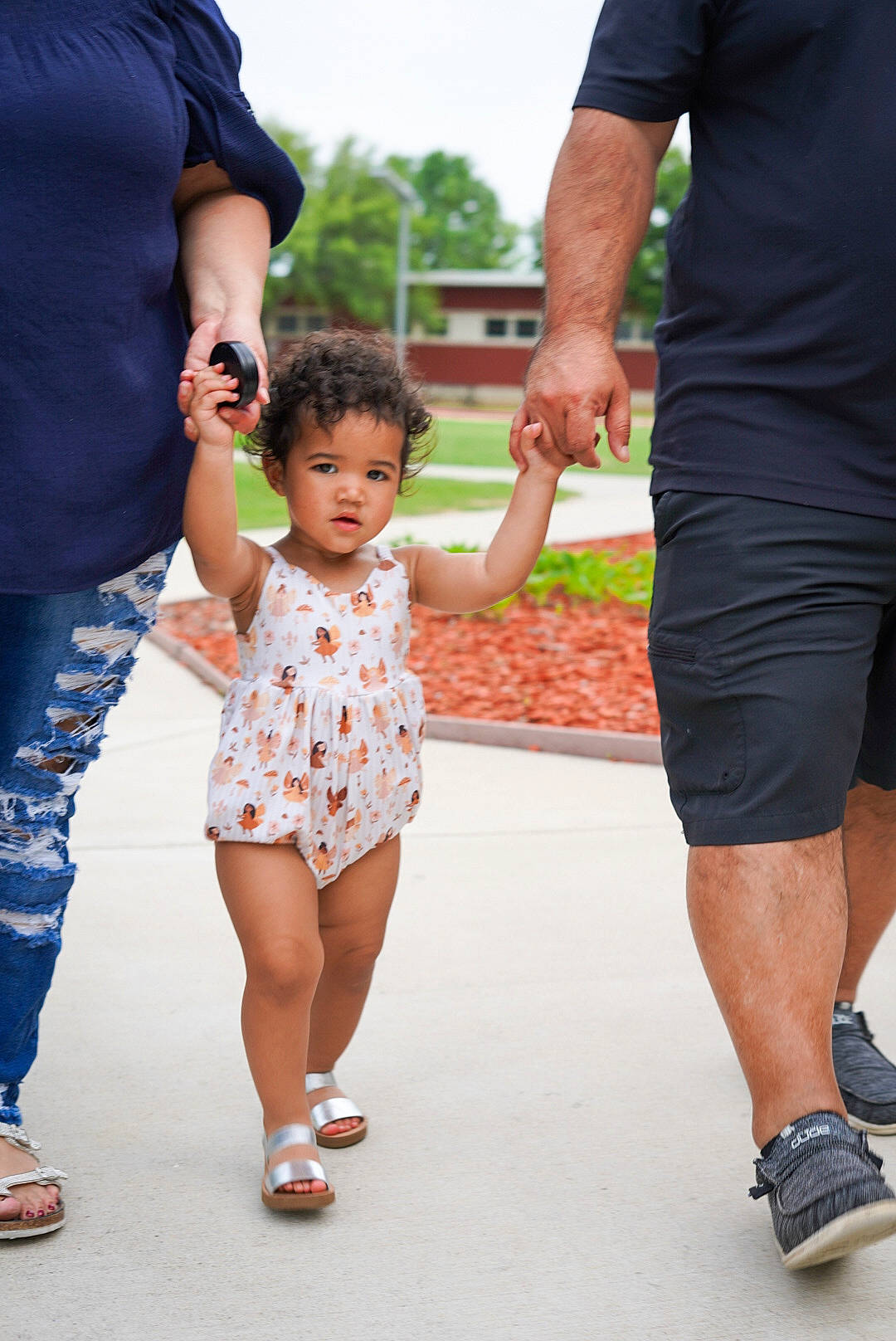 Harmony is registered to the contest to win money with this photo: child, event, footwear, fun, gesture, happy, holding_hands, human, human_leg, leisure, person, product, recreation, shoe, sky, sleeve, sneakers, standing, summer, thigh