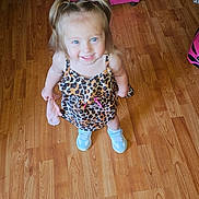 Kylie joined the competition — help win amazing prizes! blue_shoes, child, cute, dog, dress, flooring, furniture, girl, happy, home, indoor, leopard_print, person, pigtails, pink_armchair, portrait, smiling, standing, wooden_floor, young