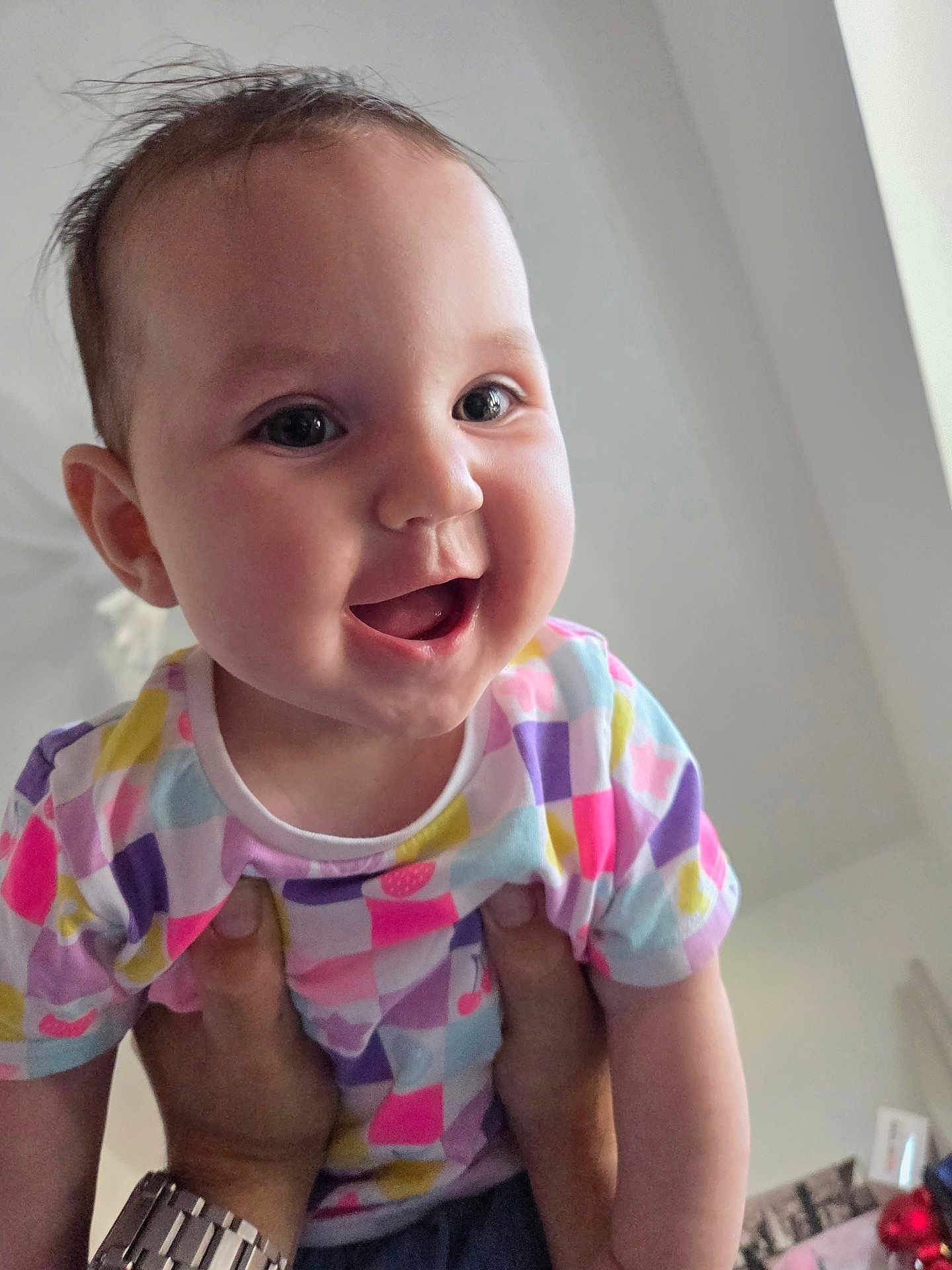 Lilianna is registered to the contest to win money with this photo: baby, child, smile, happy, colorful_clothing, indoor, person, face, hands, watch, joy, cute, infant, playful, portrait, head, cheerful, skin, short_sleeves, casual