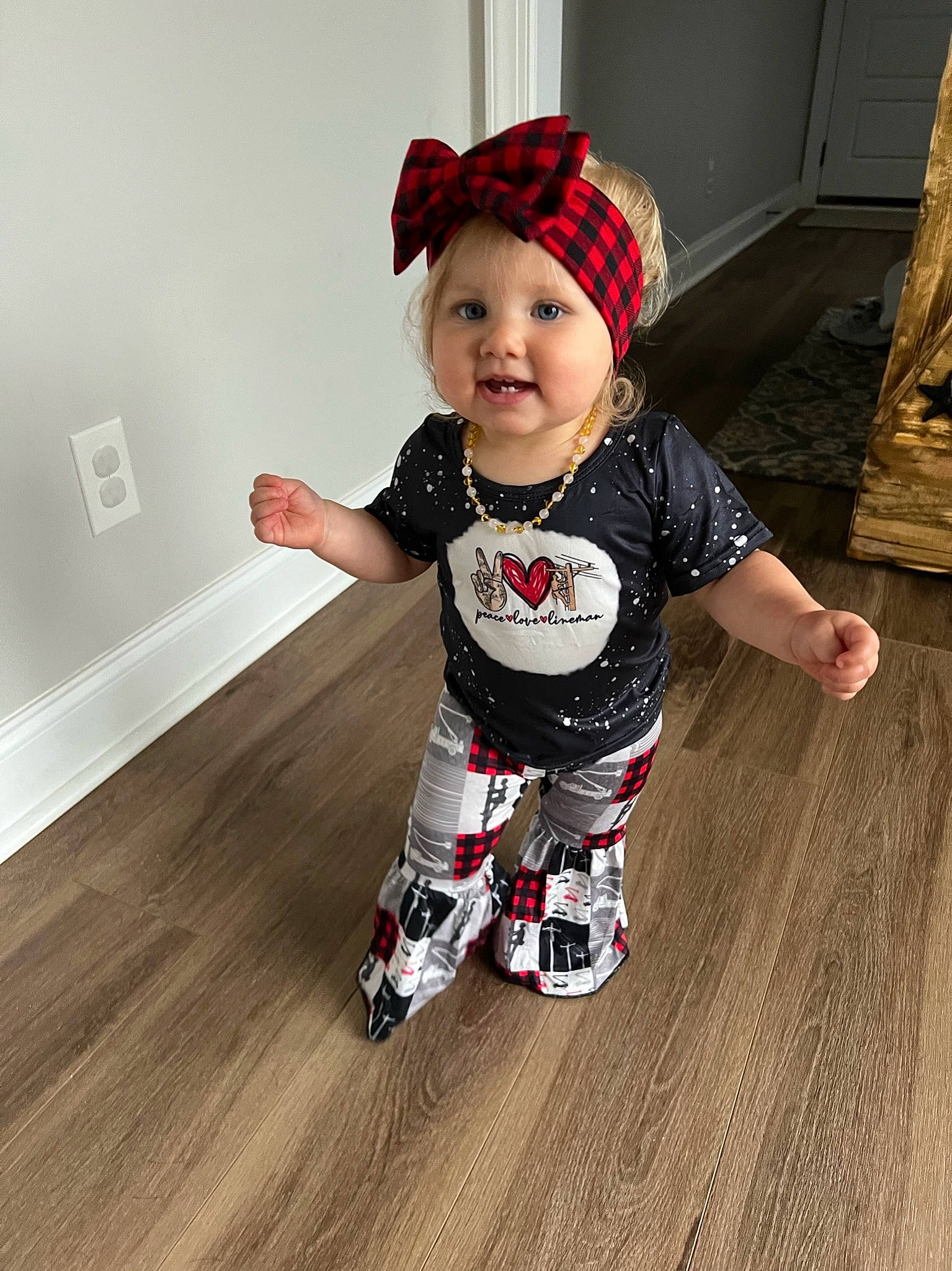 Blayklee is registered to the contest to win money with this photo: baby, baby_toddler_clothing, cap, carmine, child, costume_hat, floor, flooring, happy, hardwood, hat, headwear, laminate_flooring, pattern, person, sleeve, smile, sportswear, t_shirt, toddler