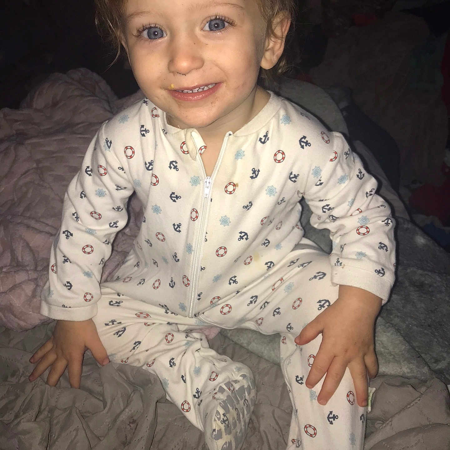 Michael is registered to the contest to win money with this photo: bed, blanket, blue_eyes, child, closeup, comfort, cute, fabric, face, footed_pajamas, hand, happy, indoor, messy_hair, onesie, portrait, sleepwear, smiling, toddler, young