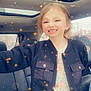 Kennedy is registered to the contest to win money with this photo: child, smiling, car_interior, rain, sunroof, jacket, pink_pants, sparkle_effect, seat, window, portrait, happy, casual_clothing, light_effect, young_girl, seatbelt, daylight, cute, indoors, playful