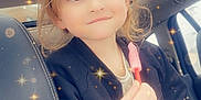 Kennedy joined the competition — help win amazing prizes! child, car, seat, popsicle, smile, sparkles, magic_effect, window, jacket, hair, face, happy, indoors, portrait, cute, young, holding, hand, seatbelt, light