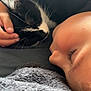 Tiago participe au concours pour gagner de l'argent avec cette photo : child, cat, sleeping, black_and_white_cat, blanket, cozy, resting, nap, close_up, face, hand, fur, eyelashes, indoor, comfort, soft_texture, quiet, friendship, peaceful, relaxation