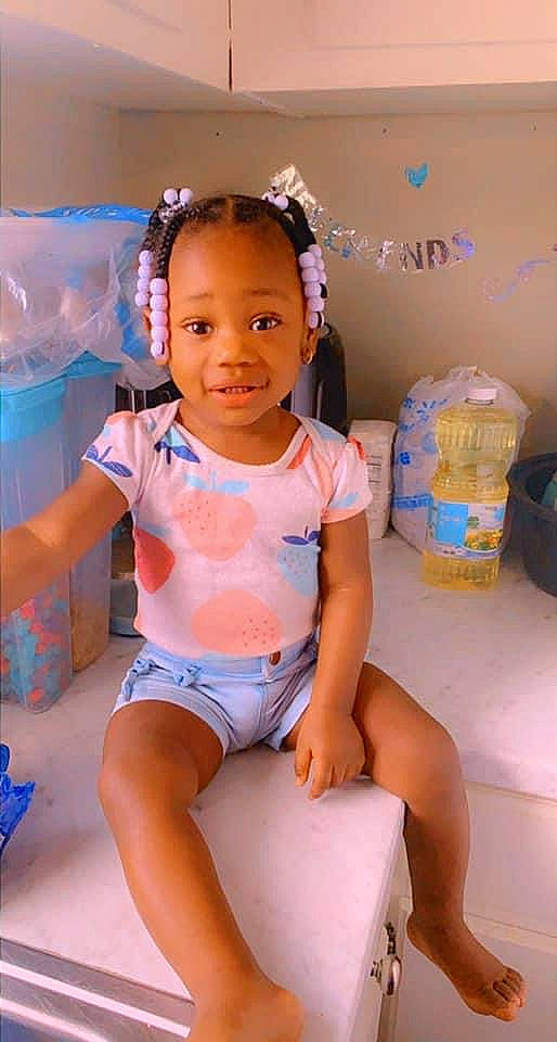 India is registered to the contest to win money with this photo: abdomen, baby_toddler_clothing, black_hair, chest, child, chin, clothing, fun, happy, human_leg, knee, leg, leisure, neck, person, pink, shorts, skin, thigh, toddler