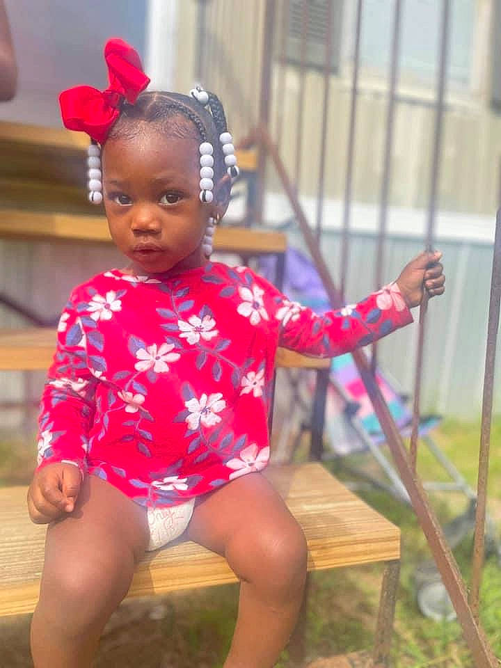 India is registered to the contest to win money with this photo: baby, baby_toddler_clothing, child, chin, event, eye, fun, happy, headband, human_leg, jewellery, leg, leisure, magenta, neck, person, pink, sitting, skin, thigh