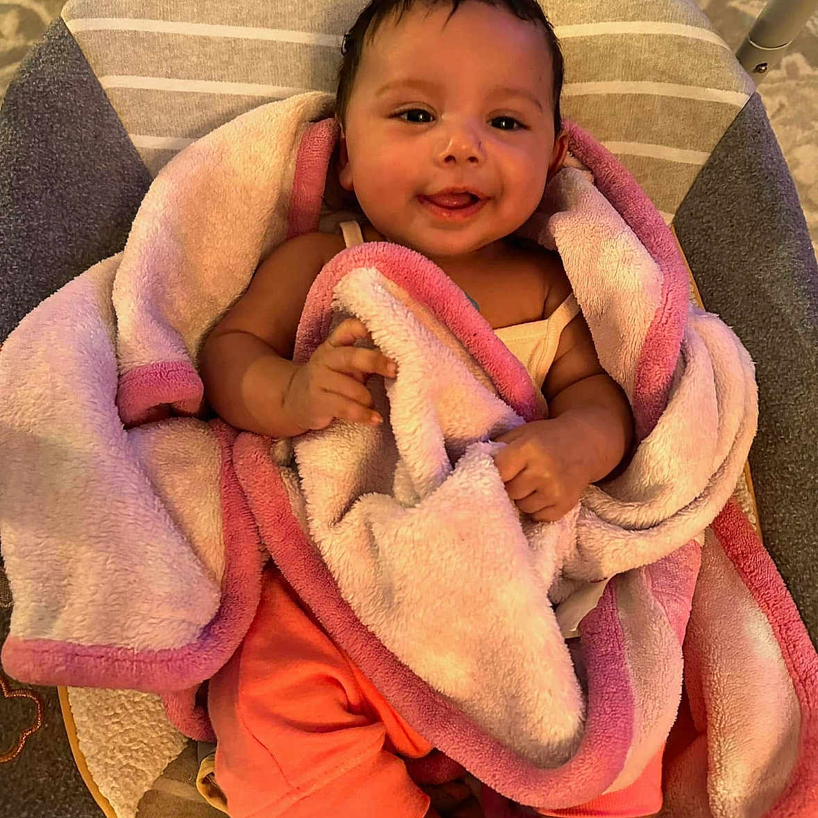 Evyana is registered to the contest to win money with this photo: baby, baby_chair, blanket, child, clothing, comfort, cozy, cushion, cute, face, happy, indoors, infant, person, pink, smile, soft, toddler, wrapped, young