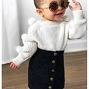 Emma participe au concours pour gagner de l'argent avec cette photo : toddler, child, sunglasses, white_sweater, pom_poms, black_skirt, buttons, standing, wooden_floor, indoors, fashion, cute, smiling, hair_bun, white_boots, person, portrait, happy, minimalistic, stylish