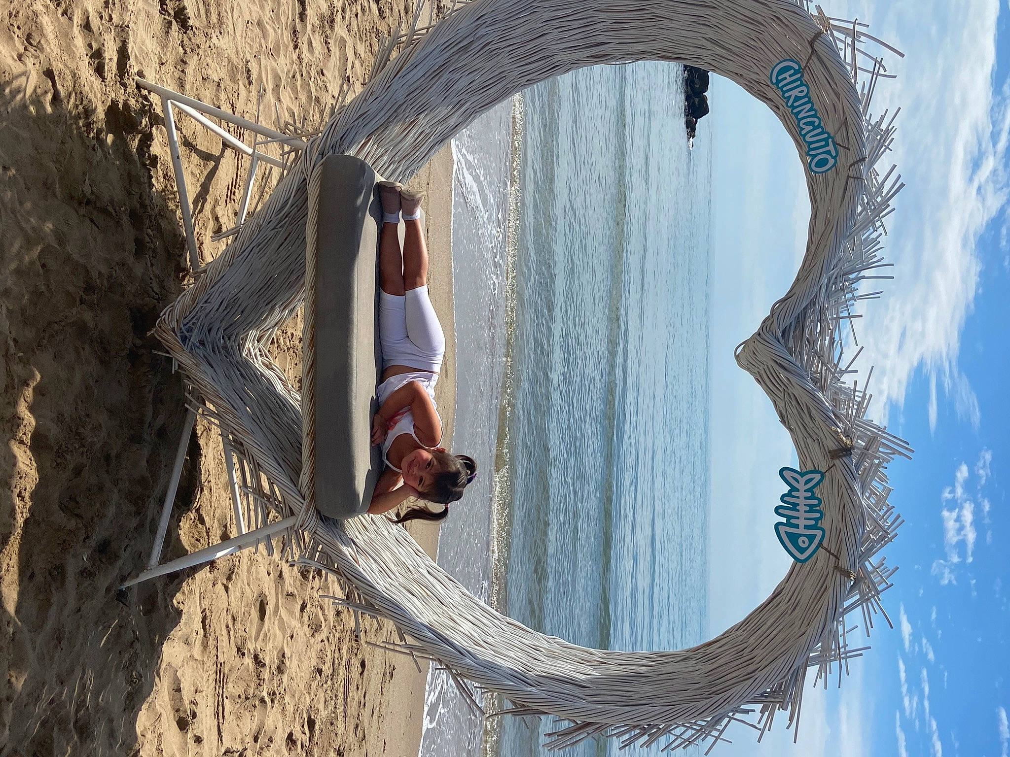 Layanna participe au concours pour gagner de l'argent avec cette photo : arch, azure, beach, beauty, blue, circle, foot, fun, joy, lake, leisure, metal, person, photograph, recreation, reflection, sky, sunglasses, water, wood