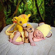 Charlie joined the competition — help win amazing prizes! animal_toy, baby, blanket, child, cozy, cute, forest_background, greenery, infant, knit_hat, nature, newborn, peaceful, plush_toy, resting, sleeping, smiling, soft_texture, stuffed_animal, yellow_hat